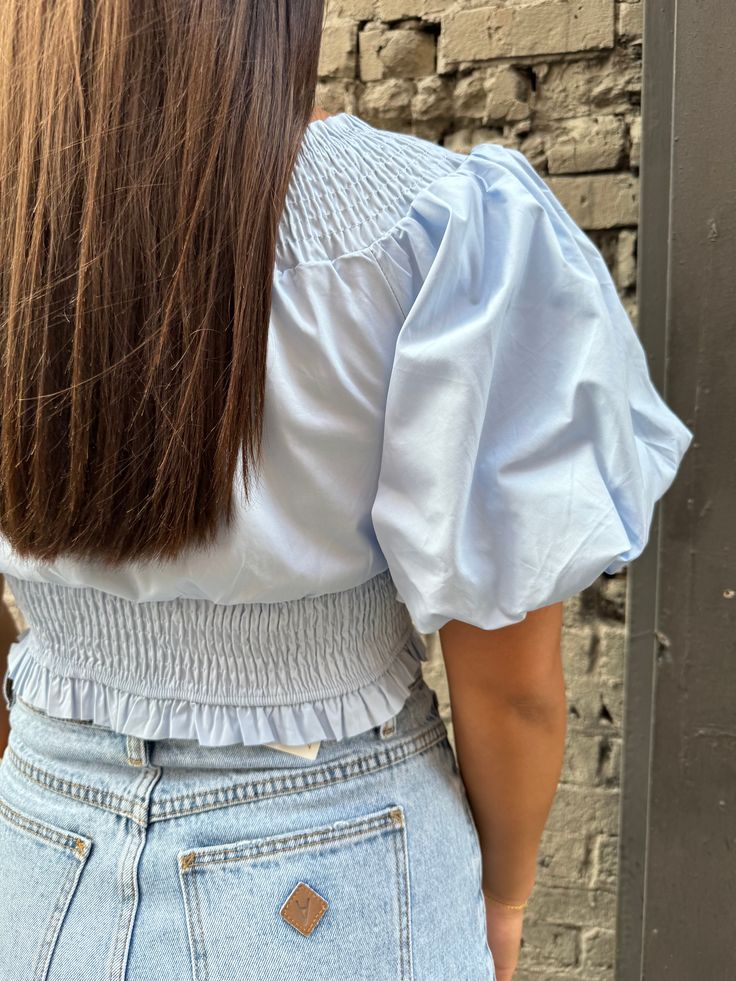 look fresh as a flower in our jasmine blouse! an ultra feminine style with its puff sleeves and a beautiful baby blue color. its smocked waist gives a flattering and comfy fit. ideal for sunny days whether paired with your fave denim shorts for casual outings or a slip skirt for a romantic date! shop more tops here! size, details & care model size Holley is 5'3" 125lbs with a 34" bust, 31" waist and 35" hip wearing a small details smocked waist self: 100% cotton lining: 100% rayon care hand wash Summer Tops With Elastic Waistband For Day Out, Trendy Light Blue Summer Blouse, Chic Summer Tops With Elastic Waistband, Summer Brunch Puff Sleeve Top With Smocked Back, Cotton Smocked Top For Spring Daywear, Spring Tops With Elastic Waistband, Trendy Cotton Tops With Smocked Cuffs, Fitted Tops With Elastic Waistband For Spring, Chic Light Blue Cotton Blouse