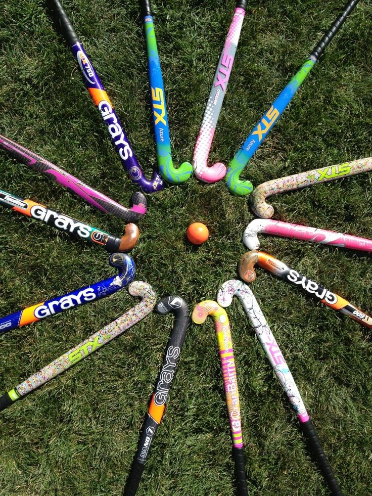 a group of crayons arranged in a circle on the grass with one ball