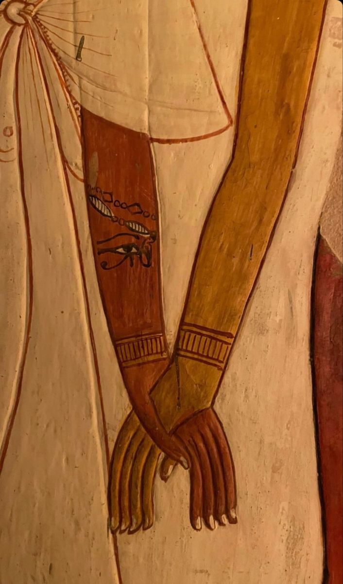 an ancient egyptian painting depicting two hands holding each other's arm, with one hand on the back of another