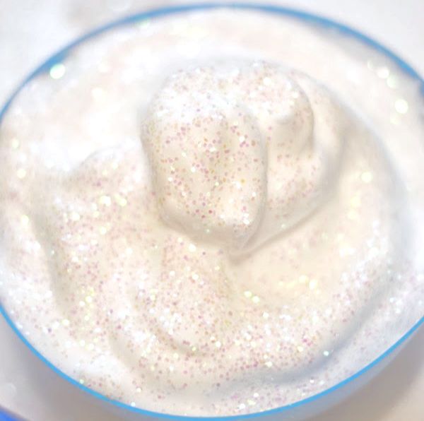 a blue bowl filled with white liquid and sprinkles on top of it