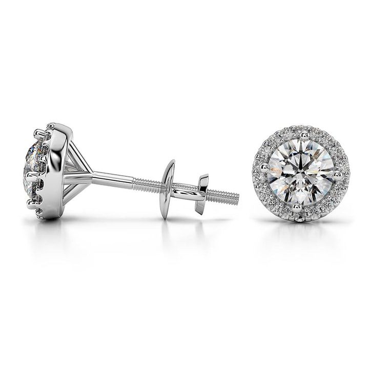 a pair of diamond earrings on a white background with clippings to the side