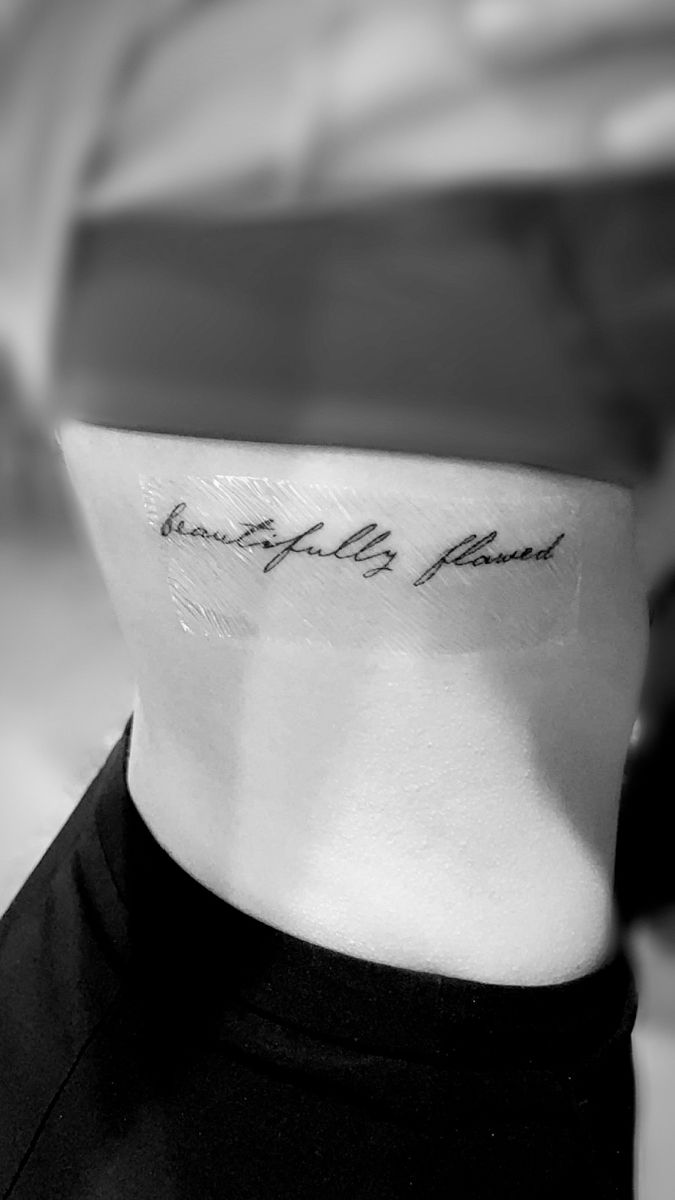 a woman's neck with a tattoo that reads, beautiful is found on it