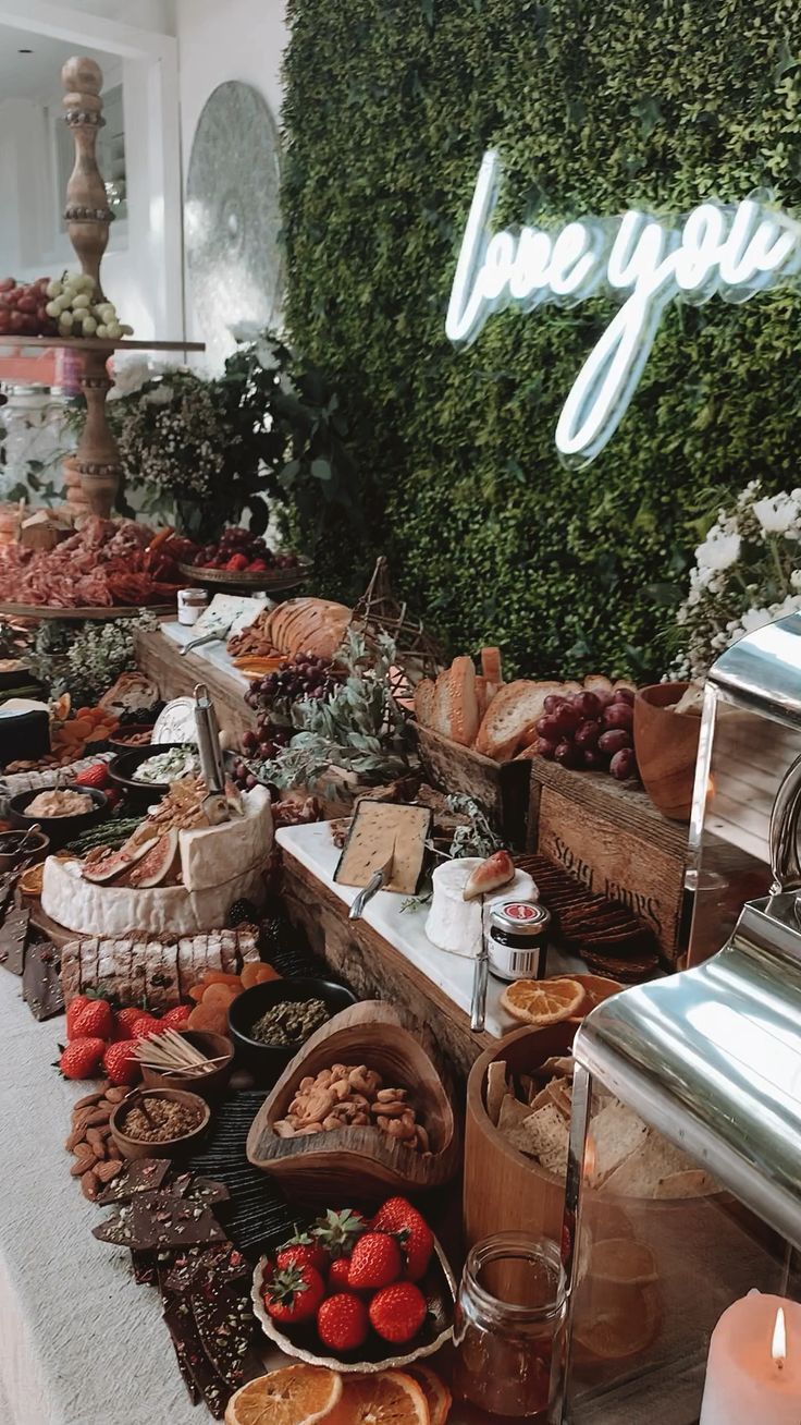 an assortment of food is displayed on a table with the words love you written above it