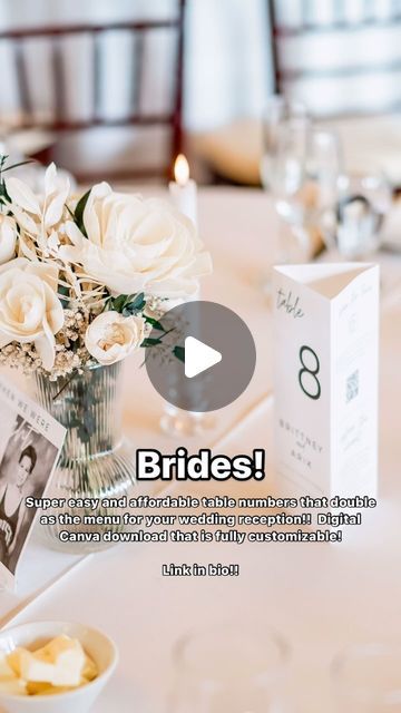 a vase filled with white flowers sitting on top of a table next to a card