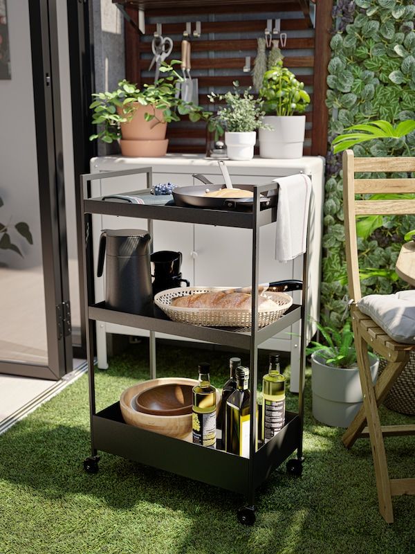 an outdoor kitchen cart with food and drinks on it