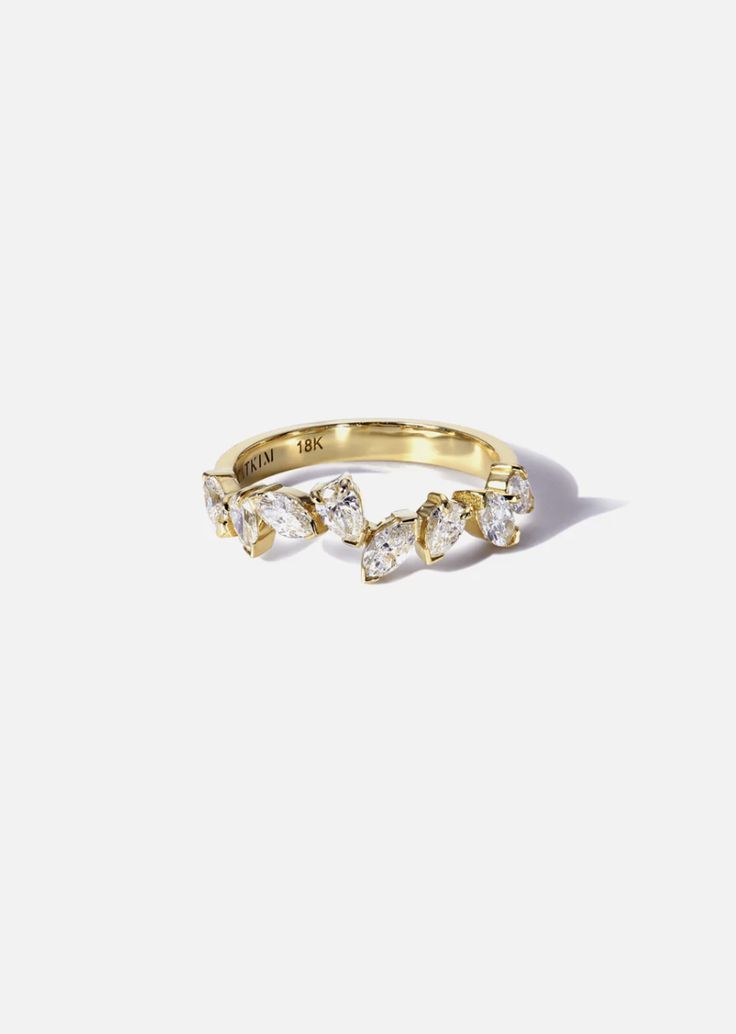 a yellow gold ring with three small diamonds on the top and one smaller diamond in the middle