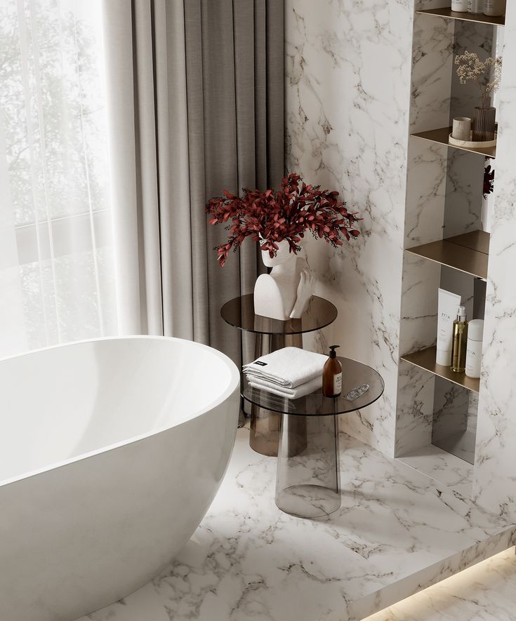 a white bath tub sitting next to a glass table with a vase on top of it