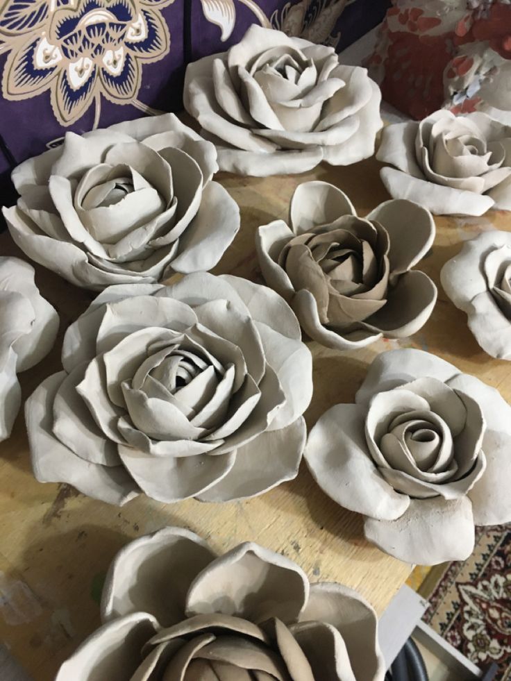 paper flowers sitting on top of a wooden table