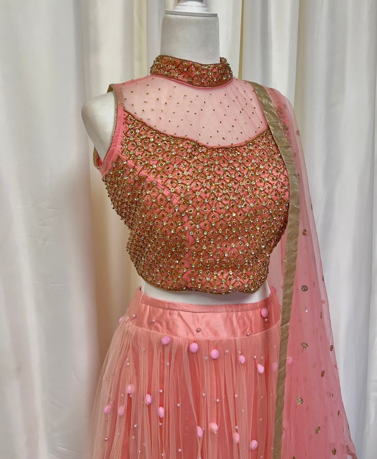 *3 Piece set - gold embellished halter blouse, net skirt, matching net shawl *Readymade: Size bust 36, 38 inches *Please message us for size customization options! *Our store is located in Los Angeles and in-store pick up is welcome! Sleeveless Party Sets With Sheer Dupatta, Embellished Organza Lehenga For Celebration, Party Lehenga With Dori Work, Sleeveless Organza Blouse Piece For Party, Pink Net Dresses For Designer Wear, Embellished Semi-stitched Lehenga For Celebration, Fitted Net Embellished Choli, Embellished Net Fitted Choli, Fitted Embellished Net Choli