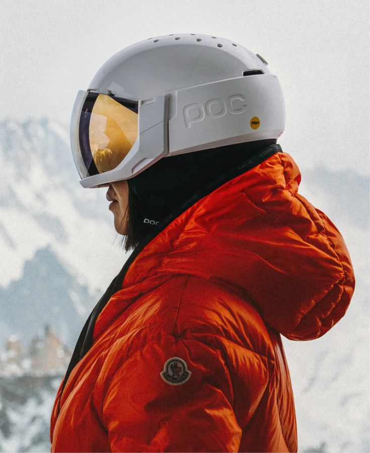 a person in an orange jacket with a helmet on