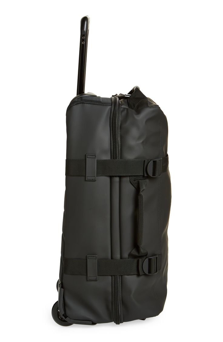 a large black bag with wheels and straps on the front, sitting against a white background