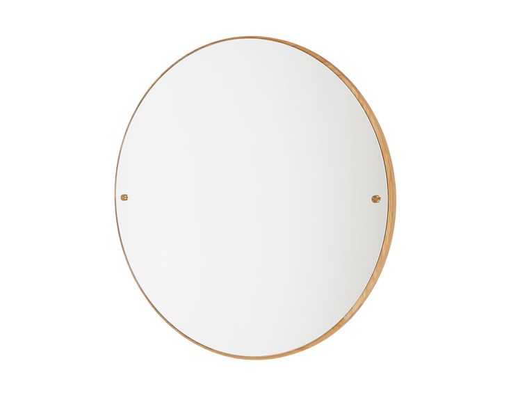 a round mirror on a white wall with gold trimmings and an oval frame