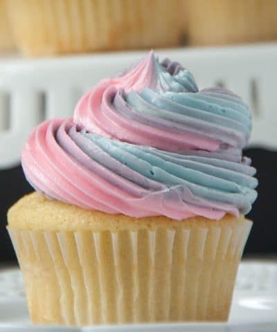 there is a cupcake with pink and blue frosting on it