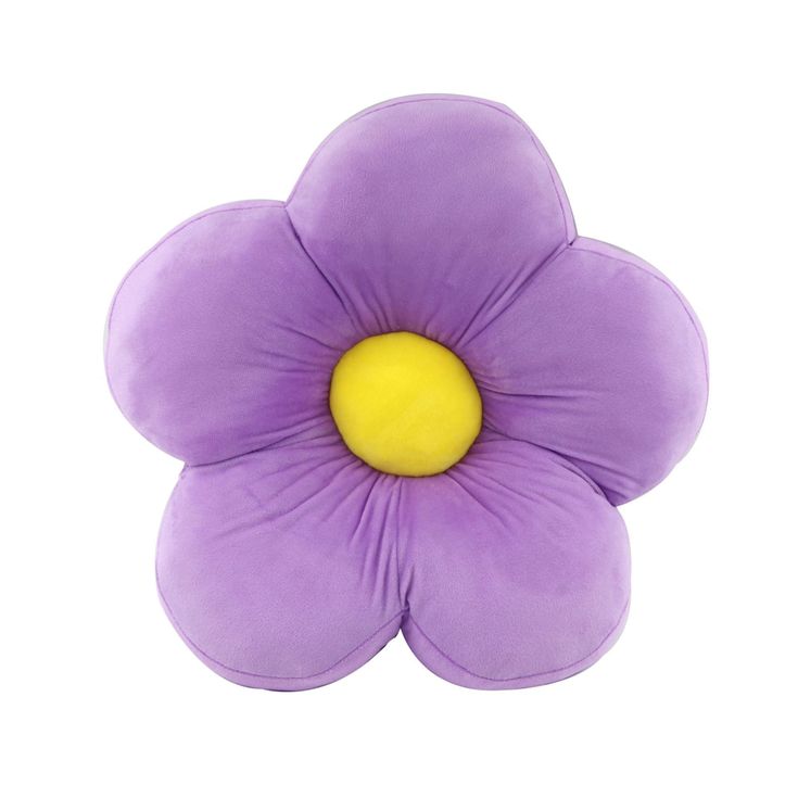 a purple flower sitting on top of a white surface