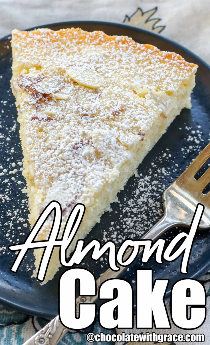 a slice of almond cake on a blue plate with a fork and spoon next to it