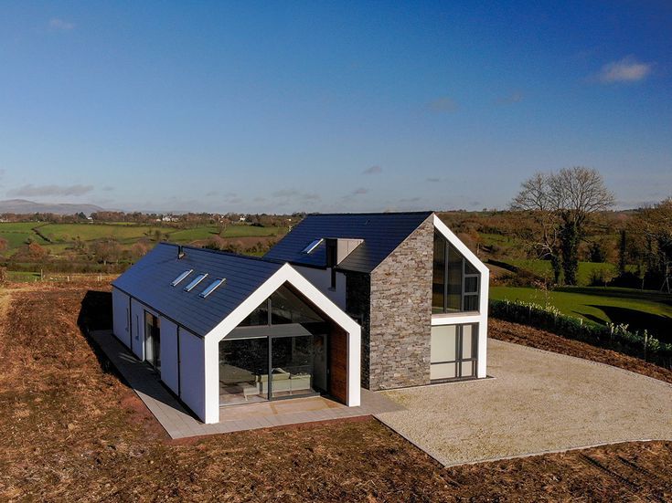 an aerial view of a modern house in the countryside