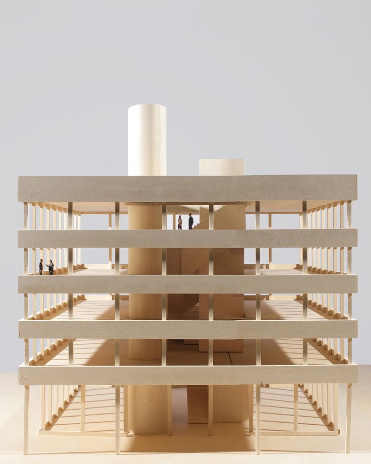 a model of a building with people standing on the top floor and stairs leading up to it