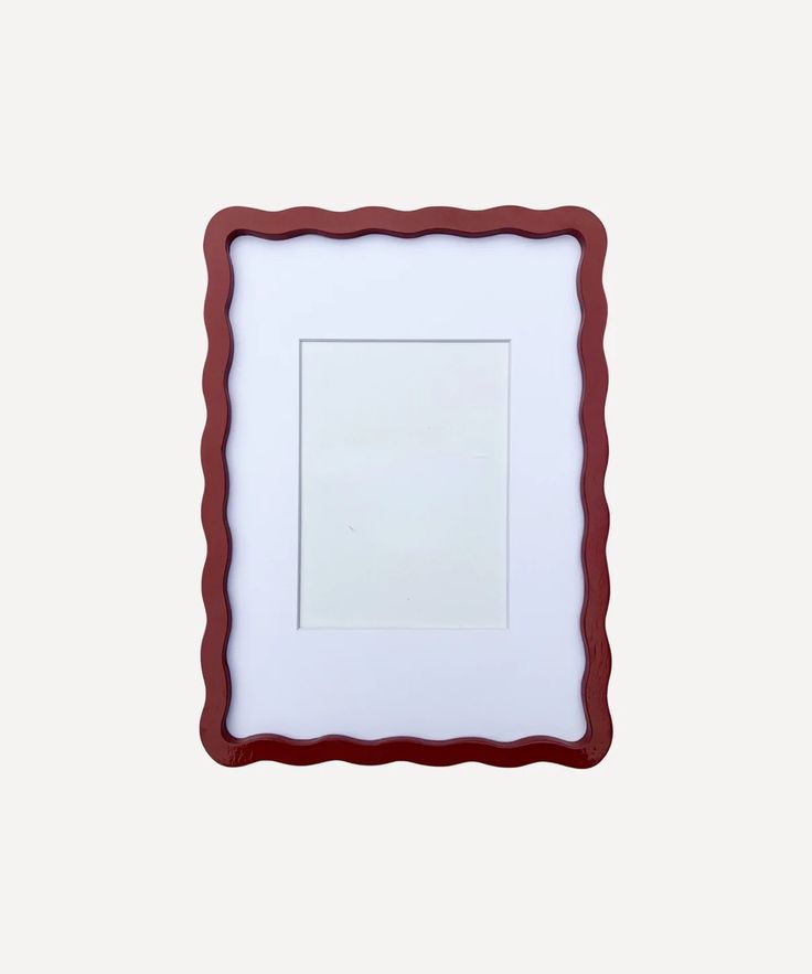 a red and white frame with a square in the middle on a white wall background