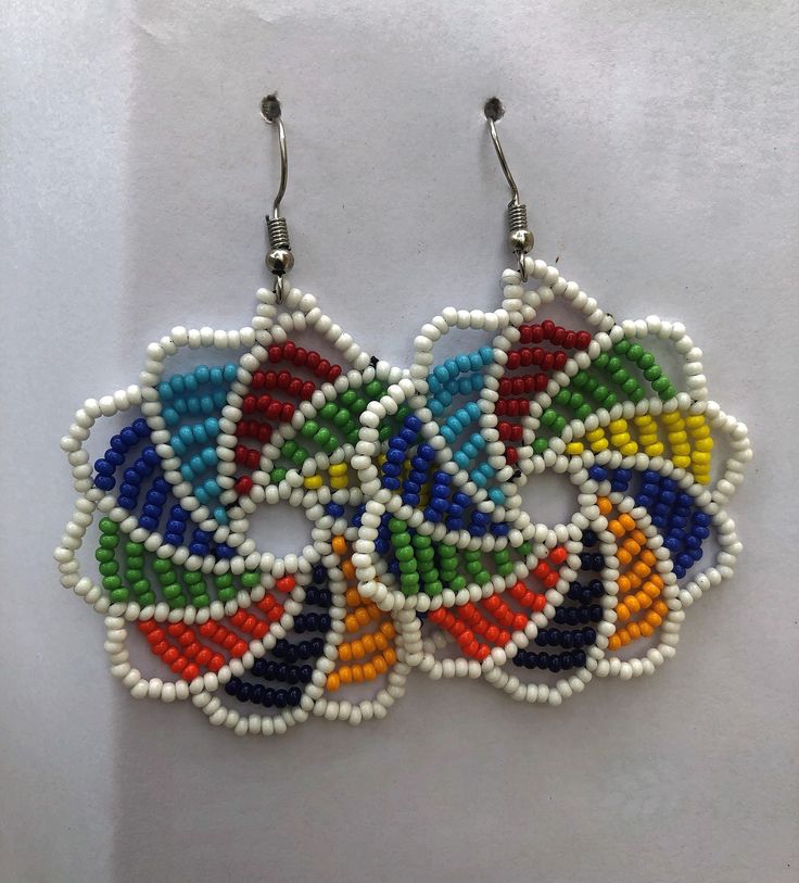 These beautiful beaded Earrings will make you look lovely like the traditional Maasai women who wear them every day in the Plains of East Africa. The Earrings are made by carefully weaving with thread and a needle. The colorful beads that are authentic and durable. The traditional Earrings have become very popular and are worn both with casual and formal wear. Go on and order your pair today and wear a piece of Africa wherever you go! Traditional Adjustable Beaded Earrings With Colorful Beads, Traditional Colorful Beaded Earrings For Festive Occasions, Traditional White Beaded Earrings For Festivals, Traditional Round Beaded Earrings With Large Beads, Traditional White Beaded Earrings With Colorful Beads, Traditional White Beaded Earrings, Multicolor Beaded Dangle Earrings, Traditional White Beads For Crafting, Traditional Dangling Beads For Crafting