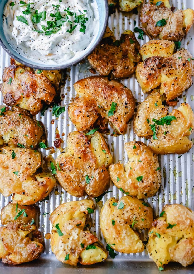 baked potatoes with cream cheese and herbs on a baking sheet, ready to be eaten