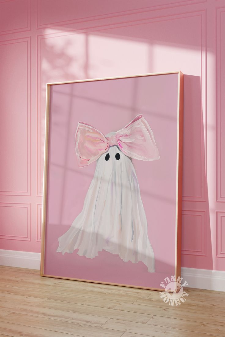 a pink room with a framed painting of a ghost wearing a pink bow on it's head