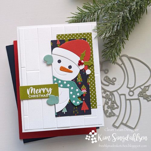 a christmas card with a snowman on it, and a pine tree in the background