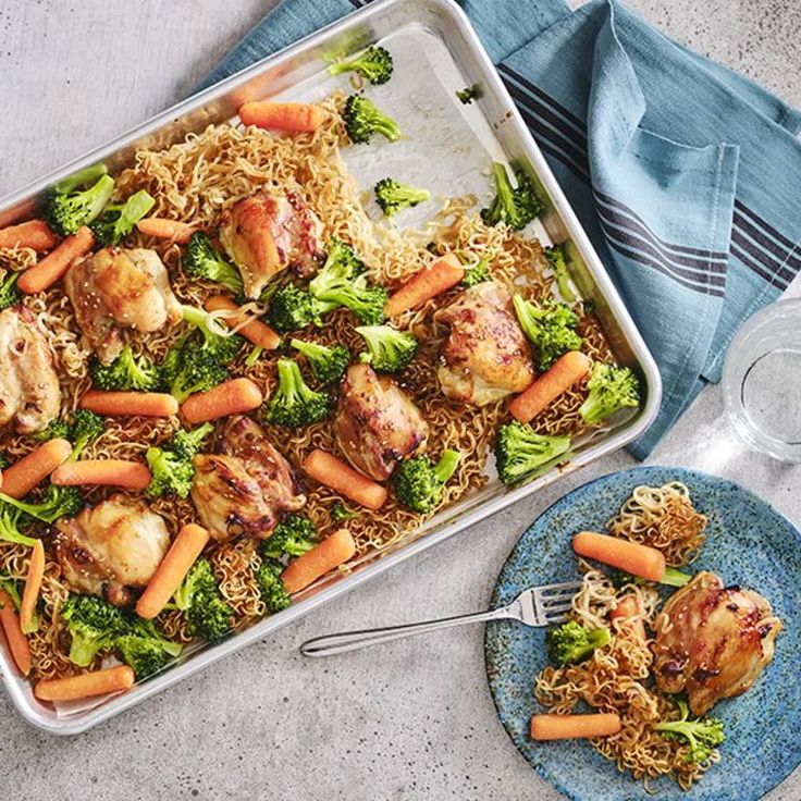 chicken and broccoli in a casserole dish next to a glass of wine