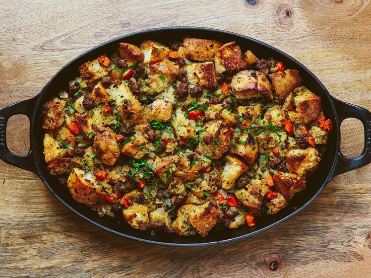 a pan filled with food sitting on top of a wooden table