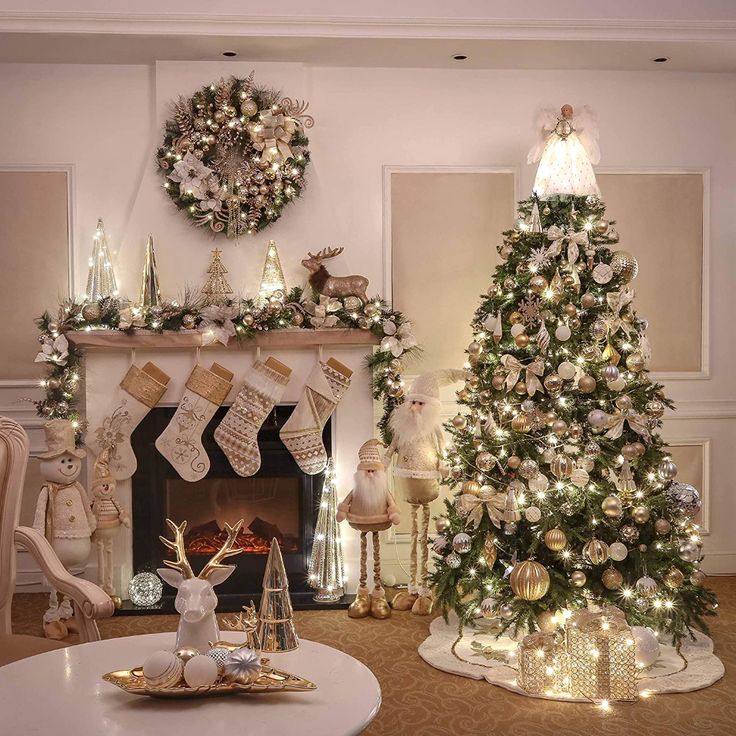 a living room decorated for christmas with white and gold decorations