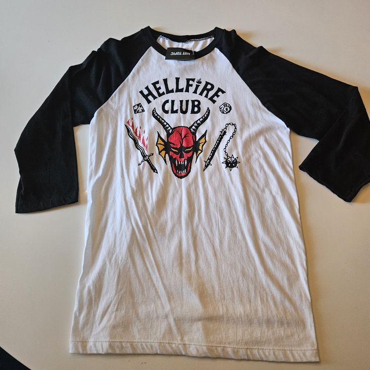 Nwt Strangerthings Hellfire Shirt From Hot Topic. White Grunge Fan Merchandise Tops, White Grunge Fan Merchandise Top, Edgy White Cotton Top, Edgy White Tops With Logo Print, Edgy White Crew Neck Shirt, Edgy White Shirt For Streetwear, Edgy White Streetwear Shirt, Edgy White Short Sleeve Shirt, White Long Sleeve Band Merch Tops