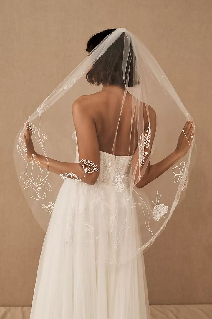 the back of a woman wearing a wedding veil