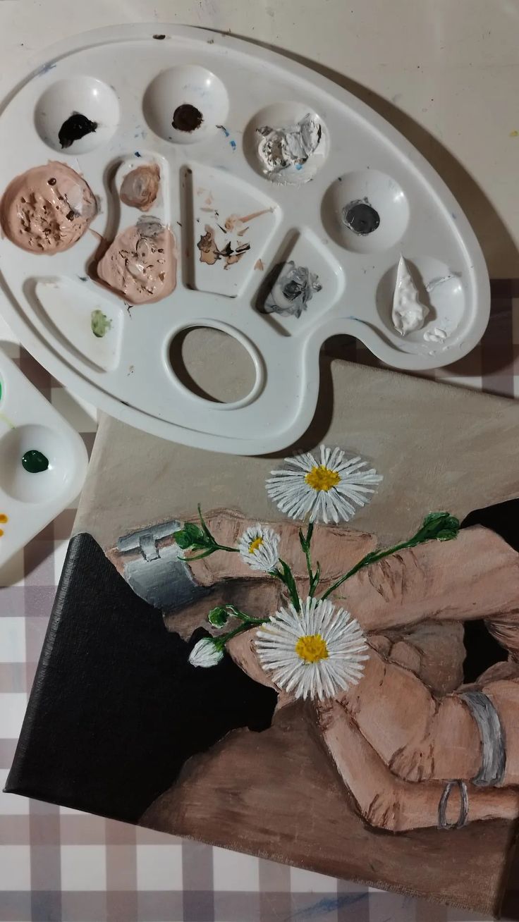 an artist's palette and painting supplies on a table