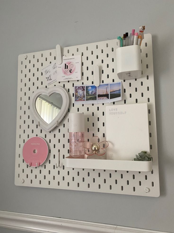 a white peg board with various items on it