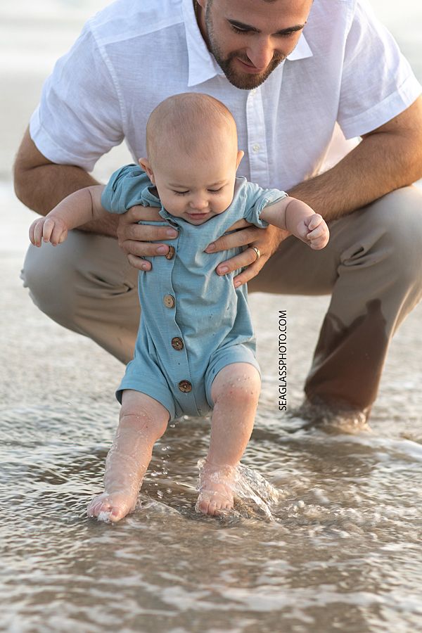 a man holding a baby in the water