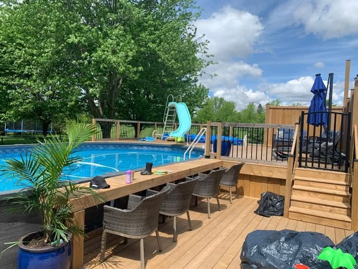 a wooden deck next to a swimming pool