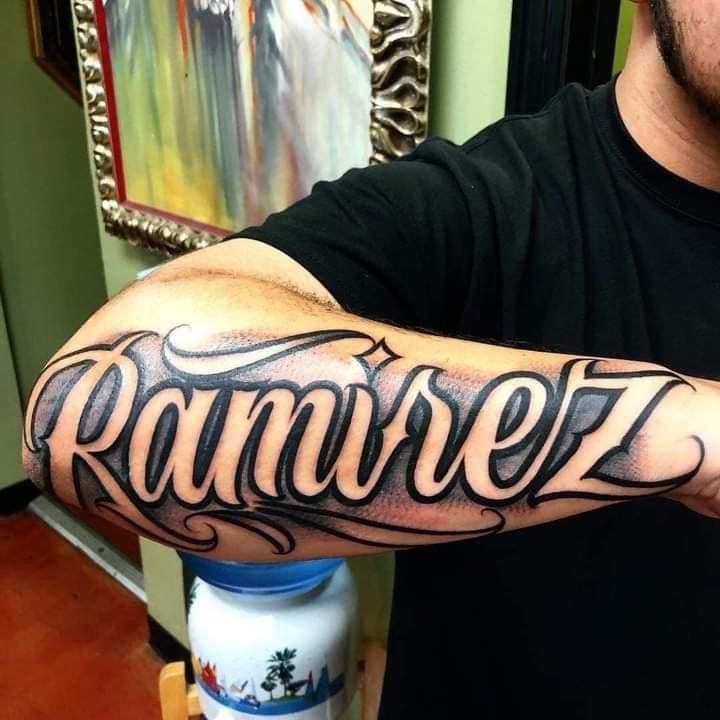 a man with a tattoo on his arm that says ranorez in cursive writing