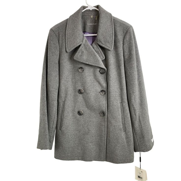 This Elegant Calvin Klein Peacoat In Size 16p Is A Perfect Blend Of Wool And Silk. Designed For Women, It Features A Double-Breasted Design In A Sophisticated Grey Color. Comes Nwt. Brand: Calvin Klein Color: Grey Size: 16p Style: Peacoat For: Women Material: Wool Silk Blend Condition: New With Tags (Nwt) Features: Retail $250 Satin Lined Extra Button Collared Hand Pockets Peacoat Fall Winter Made In China Dry Clean Size: Womens 16p Hand Measurements: Waist 42 In / 107 Cm Pit To Pit 22.5 In / 57 Calvin Klein Single Breasted Outerwear For Spring, Calvin Klein Single Breasted Spring Outerwear, Calvin Klein Single-breasted Spring Outerwear, Calvin Klein Single-breasted Outerwear For Spring, Calvin Klein Business Outerwear For Spring, Classic Single Breasted Calvin Klein Outerwear, Calvin Klein Button Closure Fall Outerwear, Calvin Klein Fall Outerwear With Button Closure, Calvin Klein Button Closure Outerwear For Work