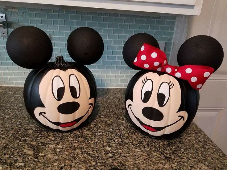 two mickey mouse pumpkins sitting on top of a counter