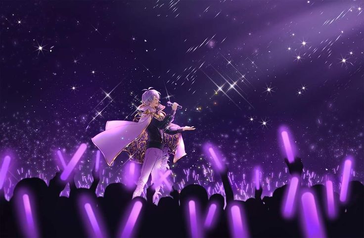 a woman on stage performing in front of an audience at a concert with purple lights