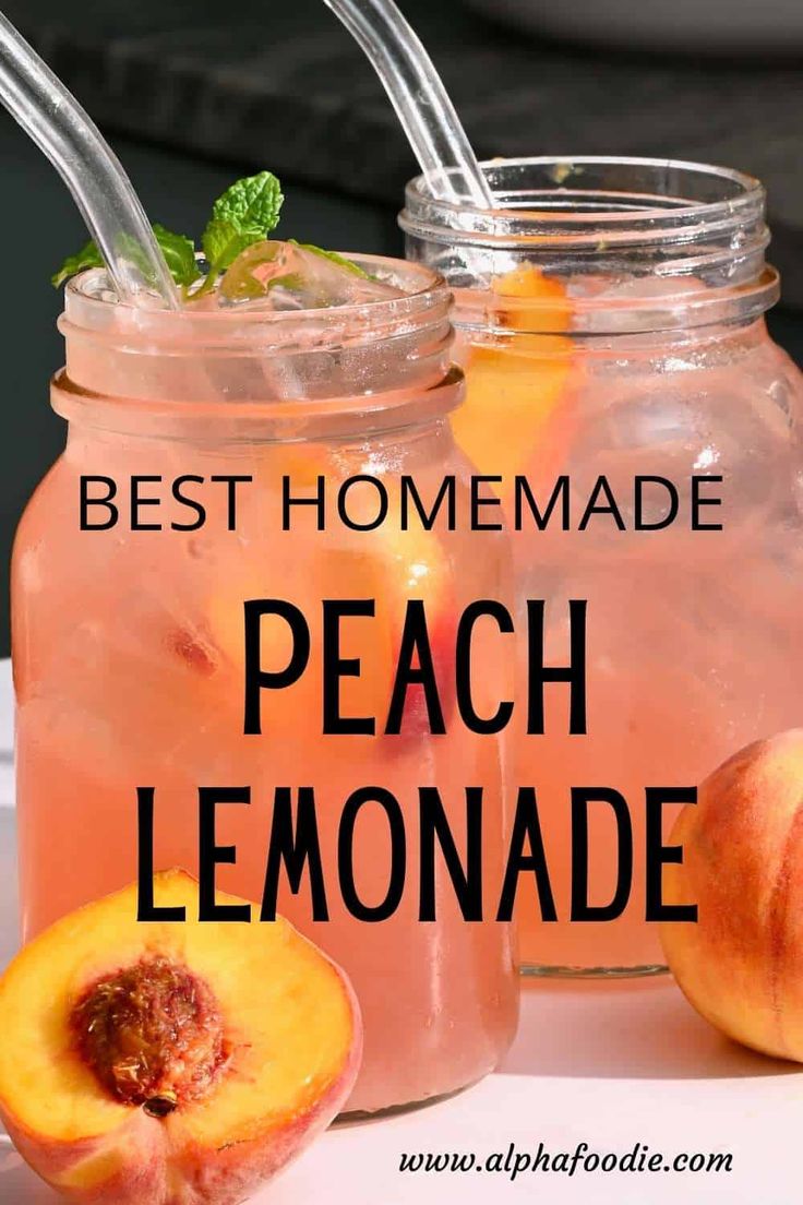 two jars filled with peach lemonade sitting on top of a table