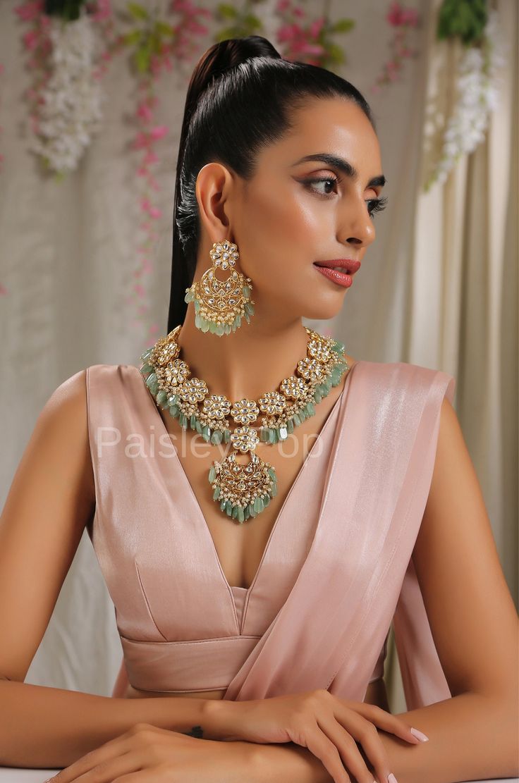 The Kundan necklace set with fluorite stones is a beautiful piece of bridal jewelry designed and handcrafted by Indian artisans with traditional Indian Jewelry making techniques The lustrous beauty of the antique Kundan gold-plated necklace set let you imagine the future that instills a sense of nostalgia and likely takes you down to old memories. India-inspired Kundan necklace set is an epode to the rich culture of India with its drooling little pearls above the fluorite stones that bring toget Indian Bridal Necklace, Bridal Necklace Indian, Culture Of India, Jewelry Kundan, India Inspired, Kundan Necklace Set, Traditional Indian Jewellery, Bridal Jewellery Design, Fluorite Stone