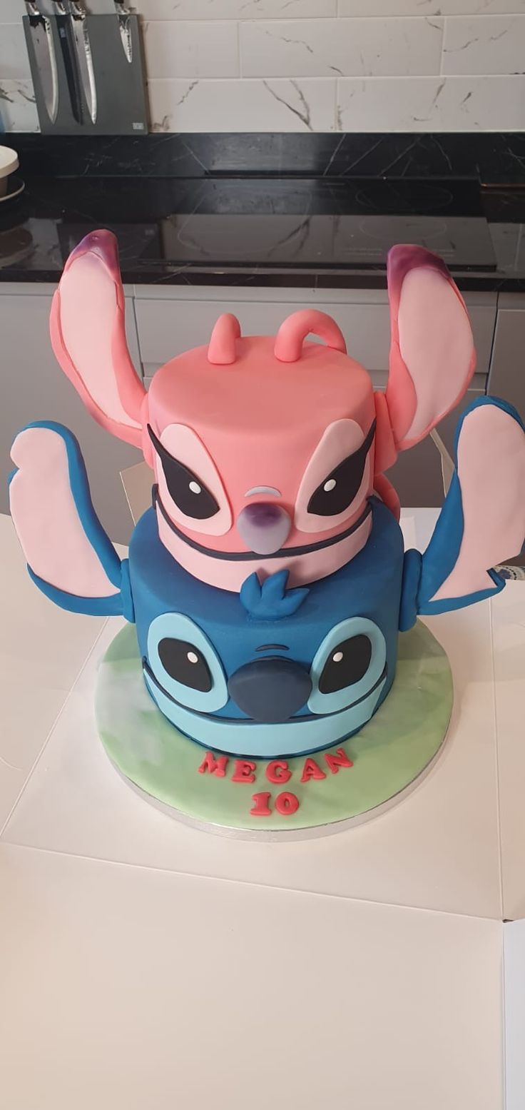 Stitch and Angel Cake 3d Stitch Cake, Stitch Cake 2 Tier, Angel From Lilo And Stitch Cake, Stitch Cake Girl, Stitch And Angel Themed Birthday Party, Stitch Birthday Cake Girl, Stitch And Angel Cakes Ideas, Lilo And Angel Cake, Stitch Birthday Party Ideas Cake