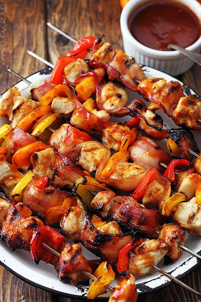 chicken and vegetable kabobs on skewers with dipping sauce