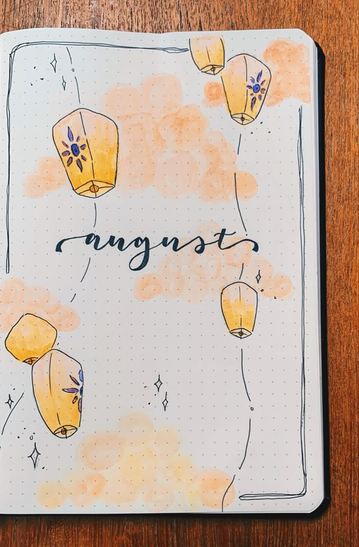 an open notebook with some yellow balloons on it and the word august written in black ink