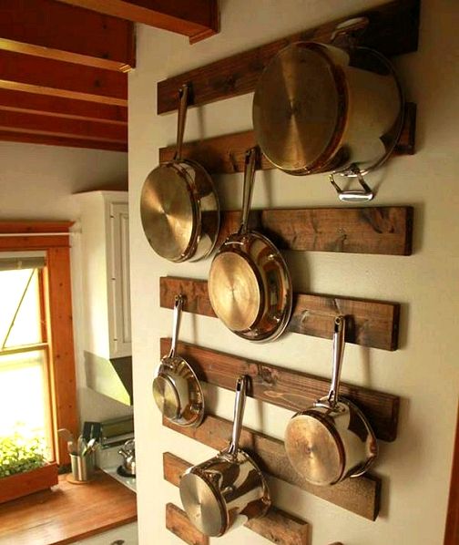 pots and pans are hanging on the wall