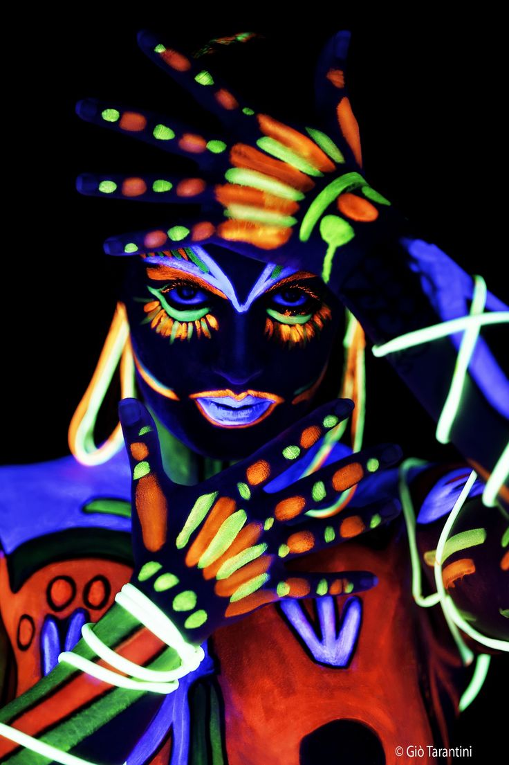 a person with neon paint on their face and body