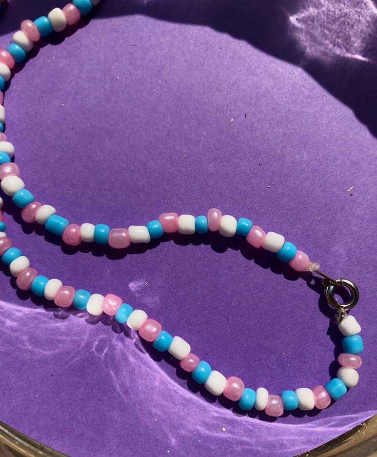 I call this one Cotton Candy. A cute and simple bright pastel beaded choker necklace perfect for spring and summer. Glass seed beads strung in a pattern on stretchy string, with a clasp in the back. Colors are pink, blue, and white. These are about 14-15 inches around, please specify if you would prefer a different length. Please note that since these are handmade and made to order, slight variations may occur. If you prefer a certain type of clasp, you can request it upon ordering, but I cannot Y2k Beach Aesthetic, Y2k Beach, Pastel Beads, Bead Charms Diy, Bright Pastels, Beaded Choker Necklace, Bead Stringing, Bead Jewellery, Beaded Choker