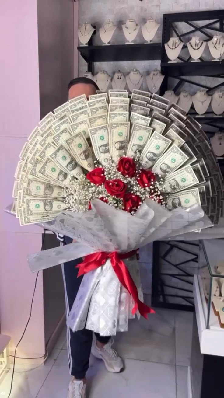 a person holding a bouquet of money and roses