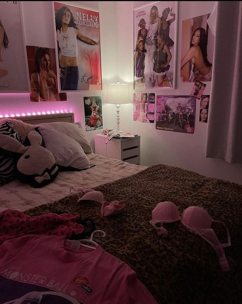 a bed room with a neatly made bed and pictures on the wall above it at night