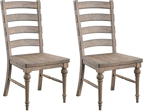 two wooden chairs sitting next to each other